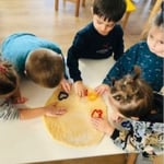 children play in a baking project at kindergarten
