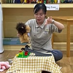 teacher plays with puppet 