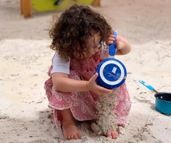 Child playing with sandbox toys