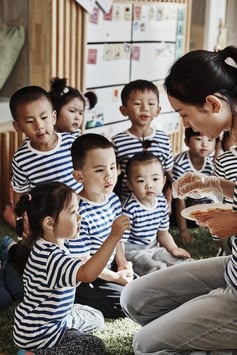 Children with their teacher at HEI Schools-1