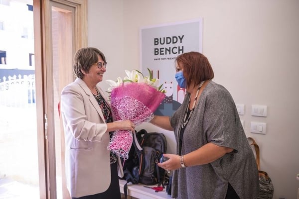 Assistant Director Dina Barakat (right) greets Ms. Kansikas-Debraise with flowers at the HEI Schools New Cairo ribbon-cutting ceremony.