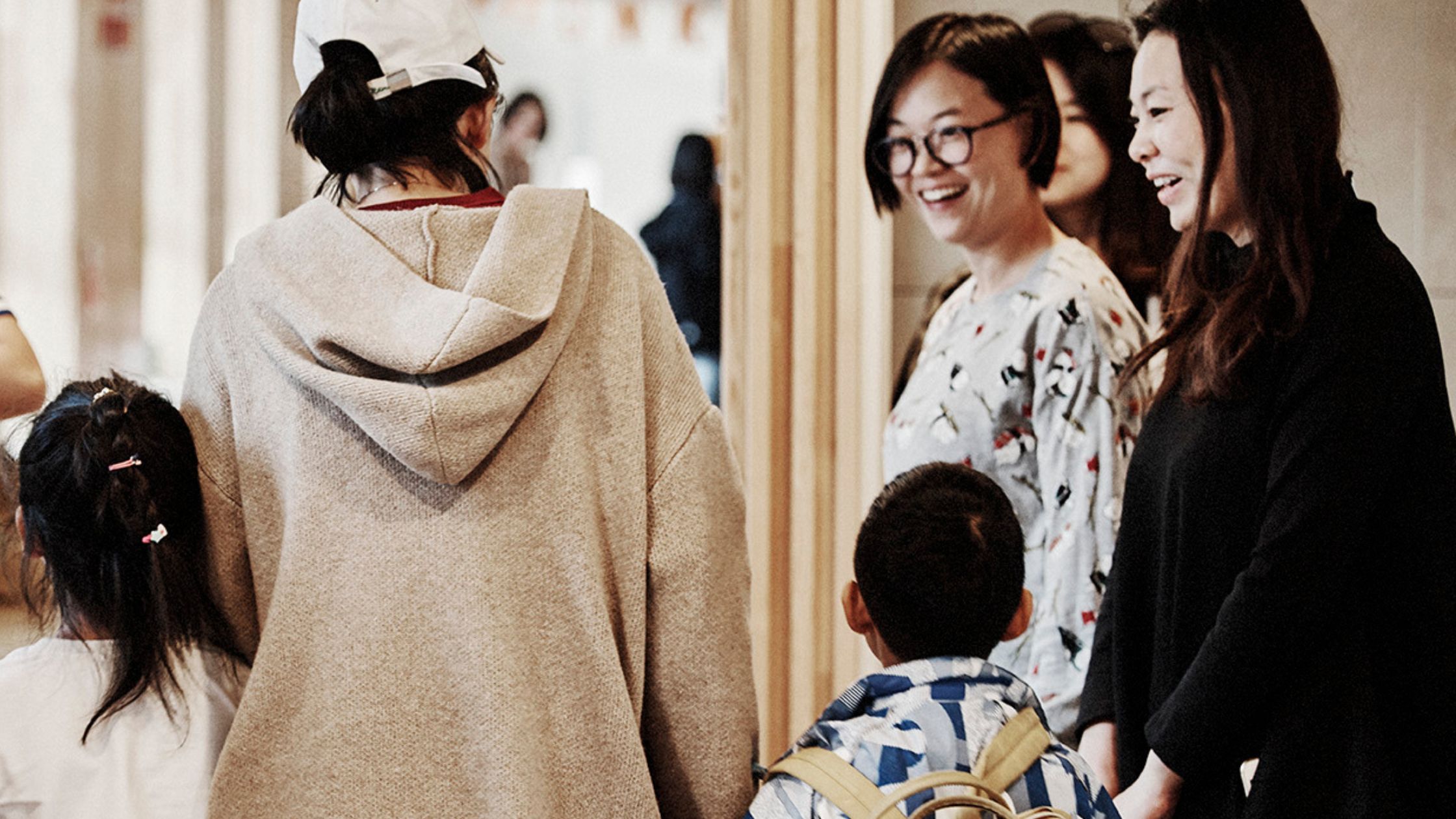 children arriving at HEI Schools with happy parents and welcoming educators