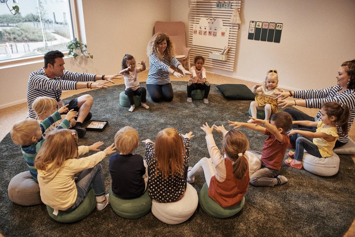 Children and teachers enjoy circle time at HEI Schools on a daily basis