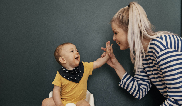 teacher and baby high fiving