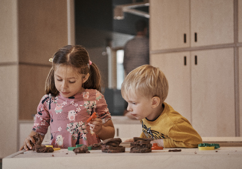 Two children play with playdough